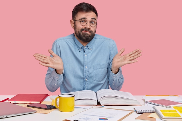 Student sitting at desk with documents