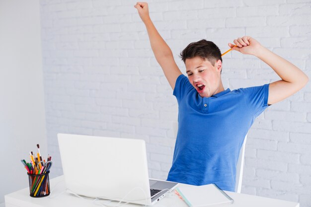 Student stretching while doing homework