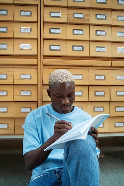 Student taking notes front view