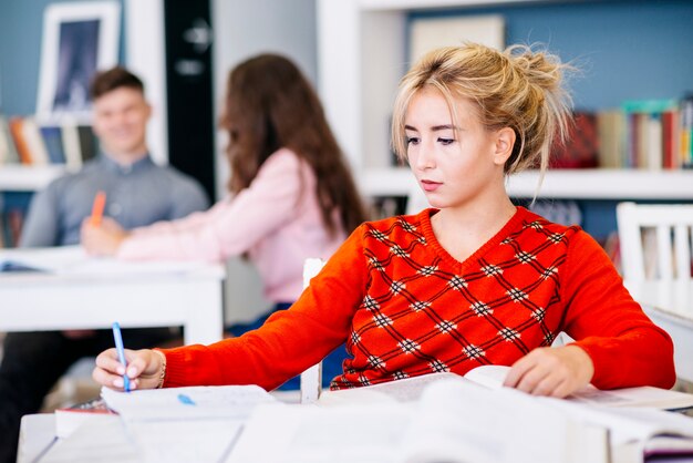 Student taking notes in library