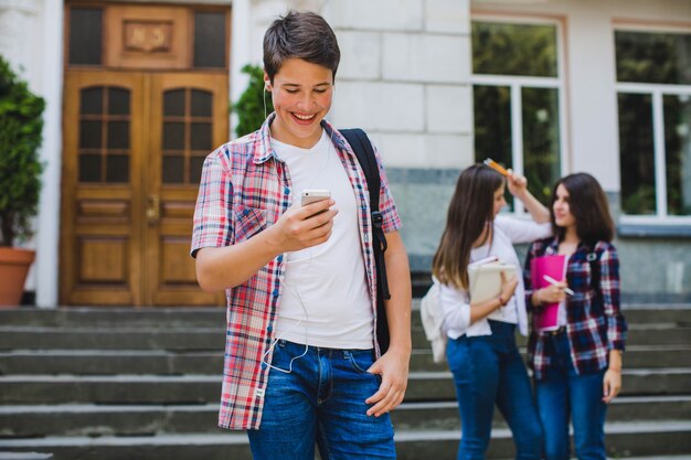 Student with phone and classmates behind