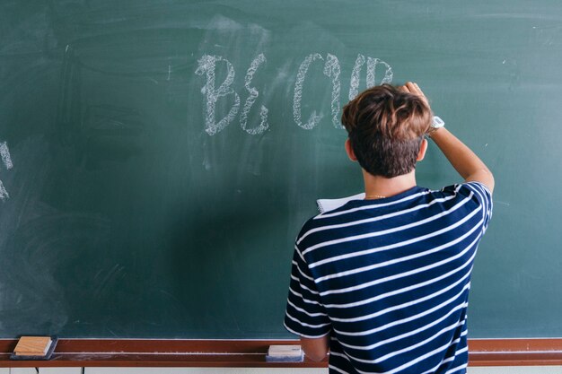 Student writing on the blackboard