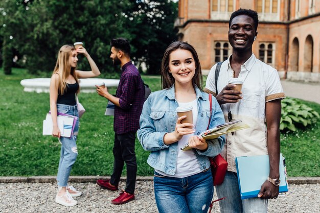 Students as colleagues in the start-up team drink coffee together and celebrate.