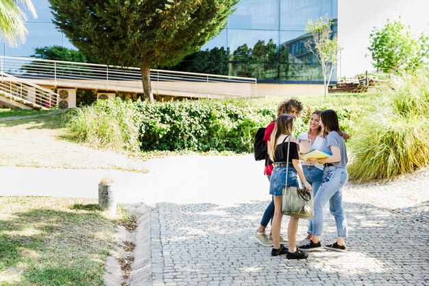 Students chatting near campus building 