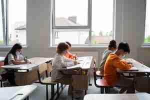 Free photo students learning at school in their classroom