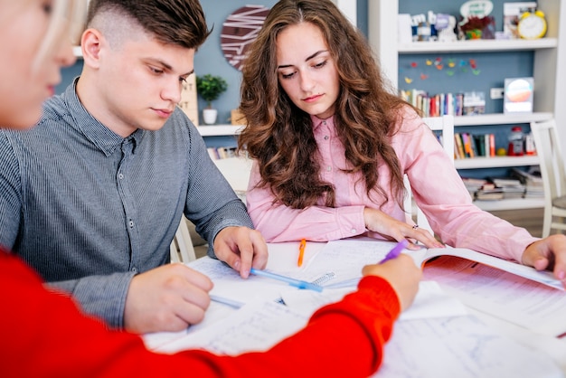 Students making assignment together in library