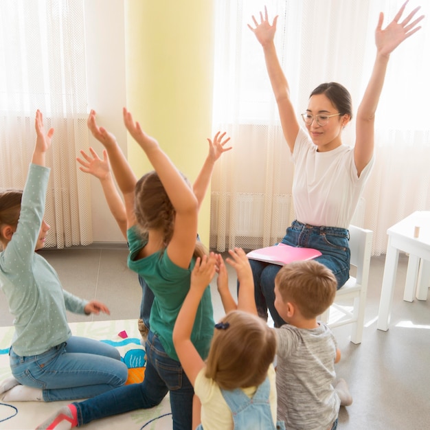 Students playing a game with their kindergarten teacher