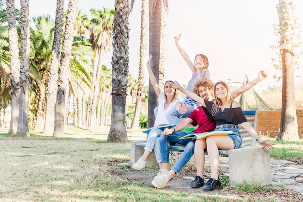 Students posing on bench in park