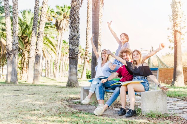 Students posing on bench in park