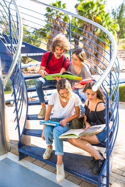 Students reading on spiral staircase