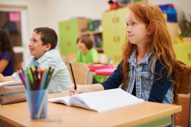 Students sitting at her desk during the lesson,