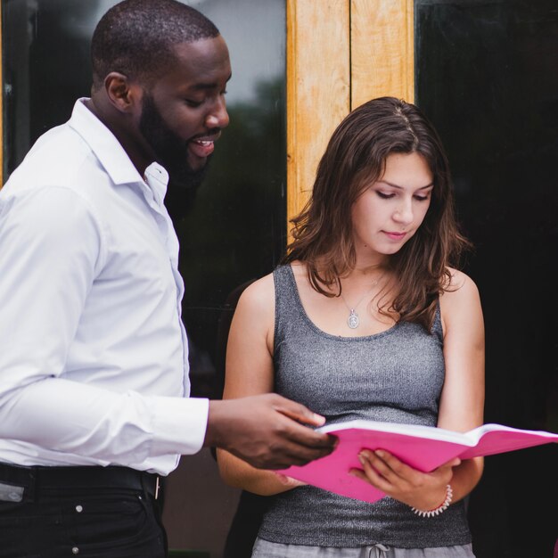 Students standing looking on notebook