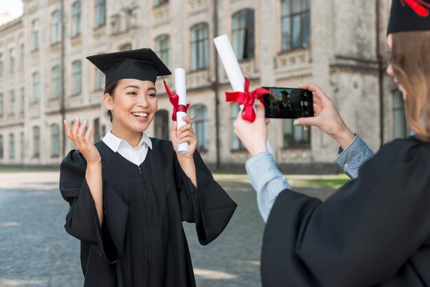 Students taking photo of each other at graduation