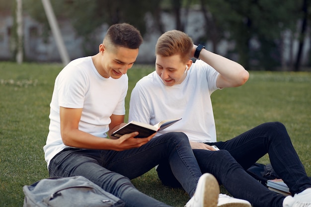 students on a university campus with a book