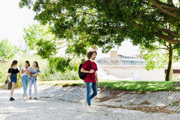 Students walking near greenery