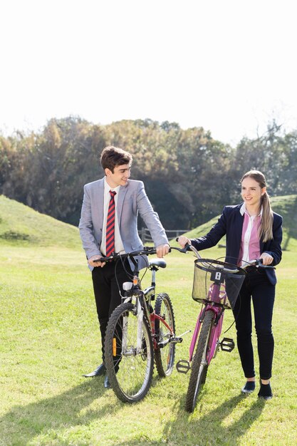 Students with bicycles walking in the countryside