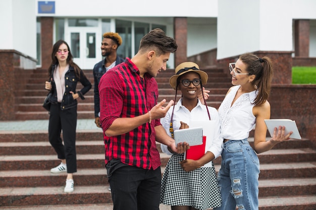 Students with tablets talking