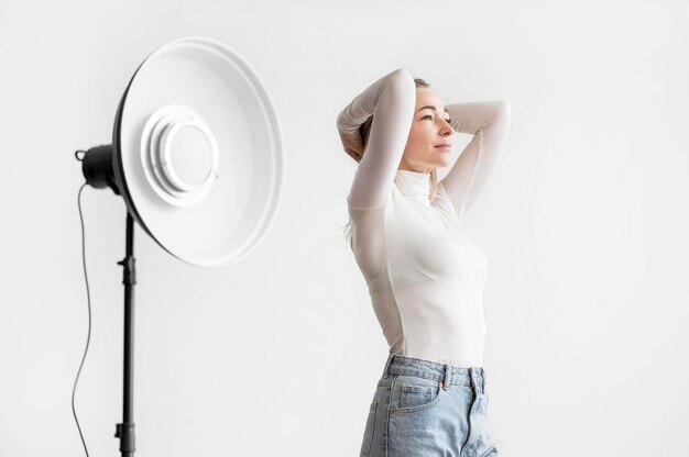Studio lamp and woman holding her head