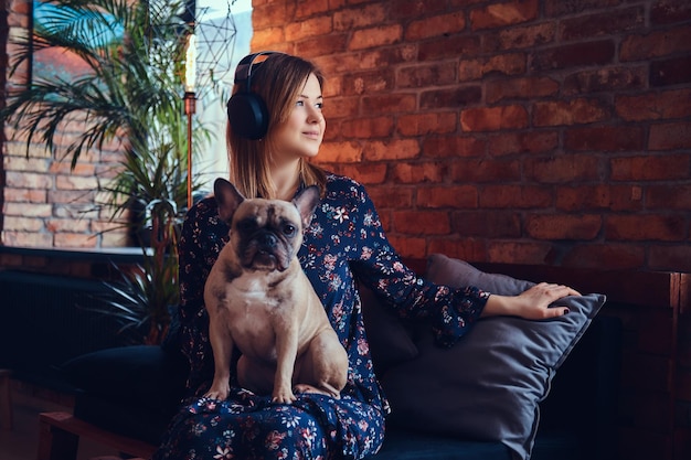 Studio portrait of an attractive happy blonde in a room with a loft interior.