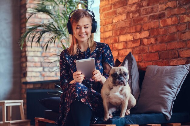 Studio portrait of an attractive happy blonde in a room with a loft interior.