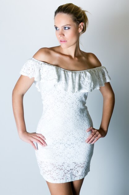 Studio Portrait of beautiful young woman posing with white screen