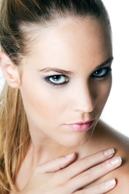 Studio Portrait of beautiful young woman posing with white screen