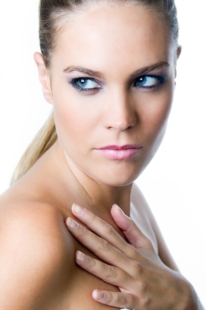 Studio Portrait of beautiful young woman posing with white screen