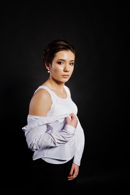 Studio portrait of brunette girl with make up on black background