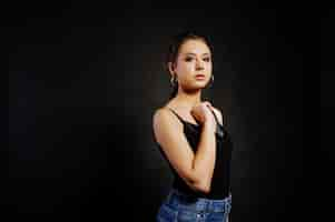 Free photo studio portrait of brunette girl with make up on black background