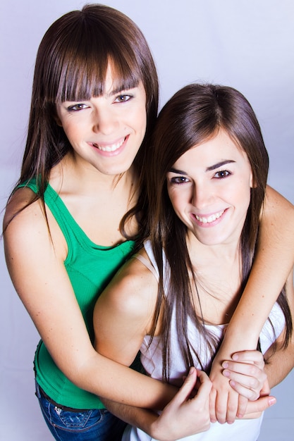 studio portrait of brunette sisters