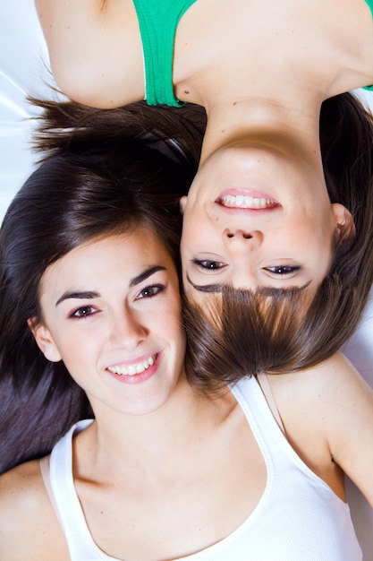 studio portrait of brunette sisters