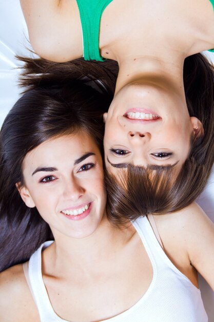 studio portrait of brunette sisters