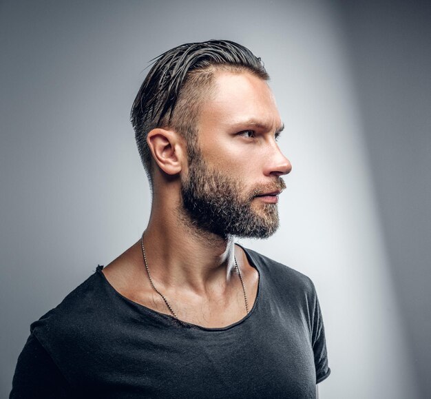 Studio portrait of fashionable modern male in grey t shirt.