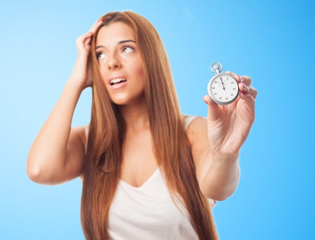 Studio portrait of girl with timekeeper