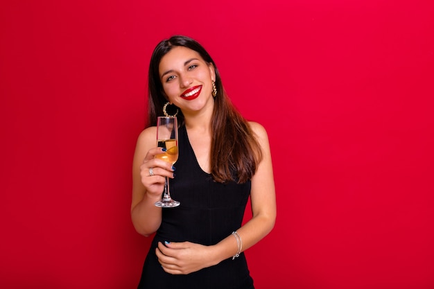 Studio portrait of graceful  woman in trendy attire chilling at a party.