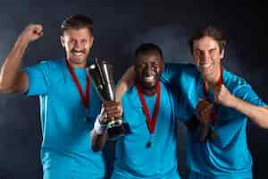 Free photo studio portrait  of handball players holding prize