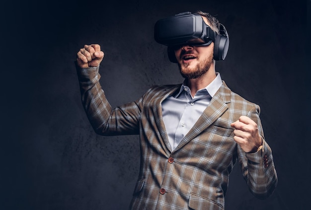 Studio portrait of a man wearing virtual reality glasses on a da