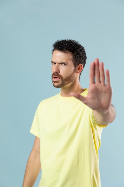 Free photo studio portrait of man in yellow t-shirt