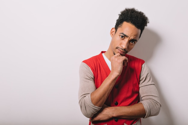 Free photo studio portrait of serious black american male dressed in a red shirt on gray