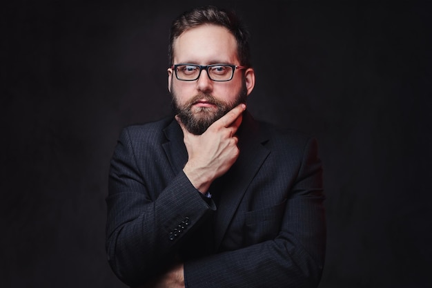 Free photo studio portrait of serious plump male in eyeglasses over grey background.