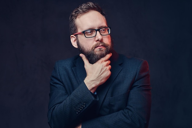 Free photo studio portrait of serious plump male in eyeglasses over grey background.