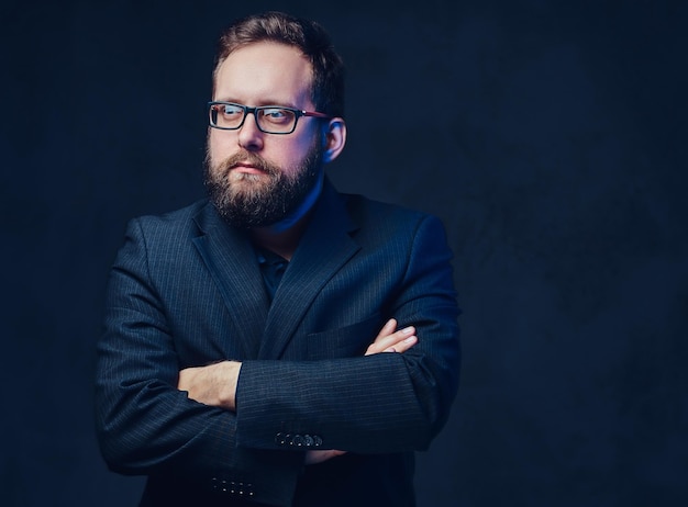 Free photo studio portrait of serious plump male in eyeglasses over grey background.