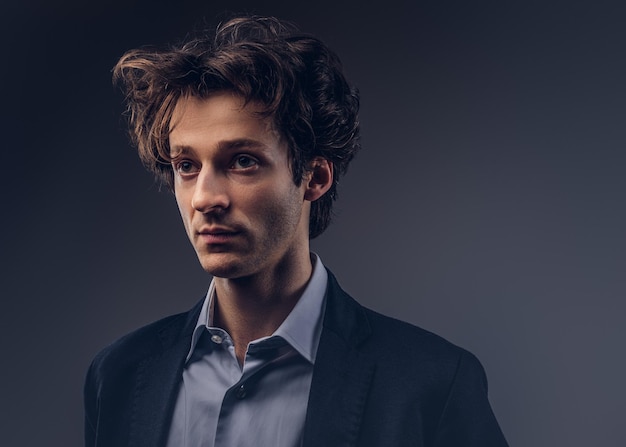 Studio portrait of a stylish sensual male with hairstyle in a casual suit