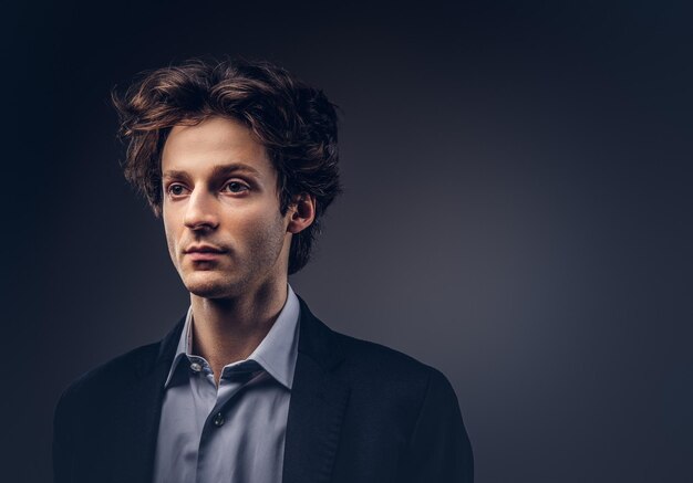 Studio portrait of a stylish sensual male with hairstyle in a casual suit