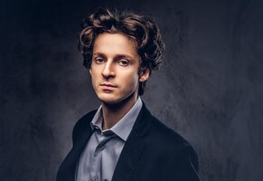 Free photo studio portrait of a stylish sensual male with hairstyle in a casual suit