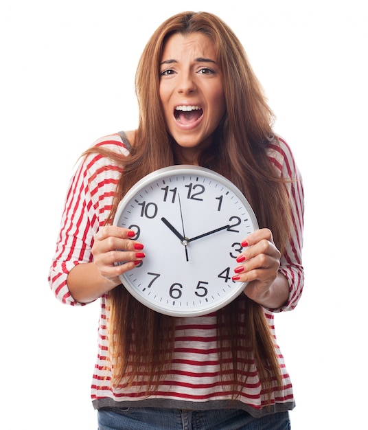 Studio portrait of woman holding rounded clock