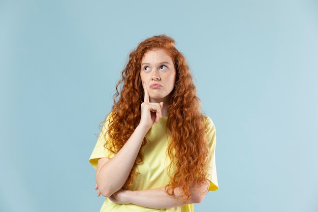 Studio portrait of young redhaired woman