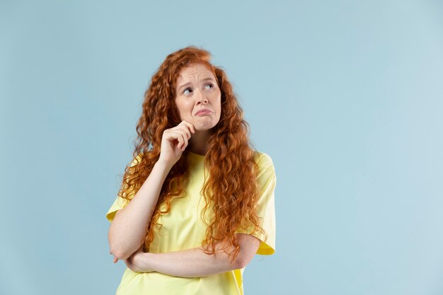 Studio portrait of young redhaired woman