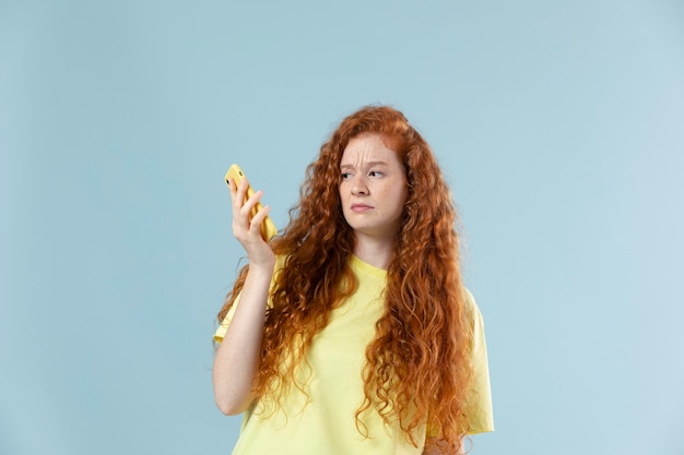 Studio portrait of young woman with red hair