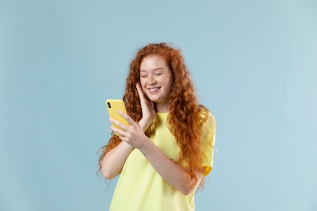 Studio portrait of young woman with red hair